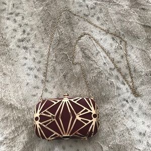 Burgundy evening clutch with gold metal detail